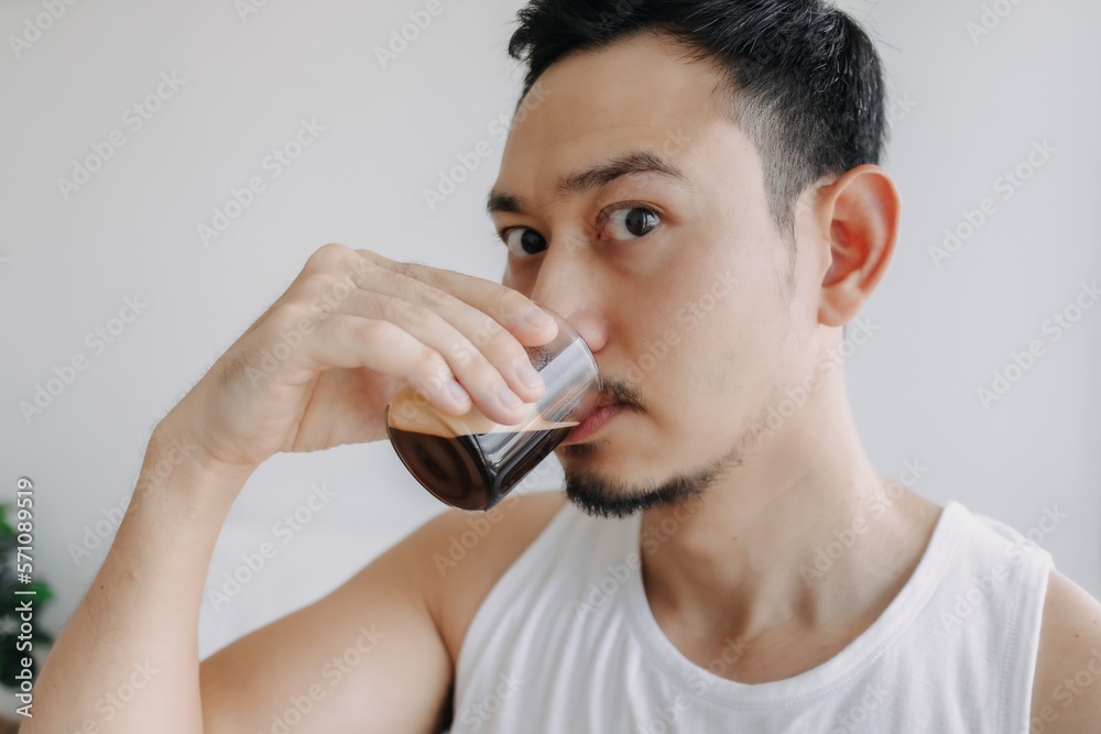 Asian man dink a shot of espresso coffee in his house for a fresh morning. Asian man dink a shot of espresso coffee in his house for a fresh morning.