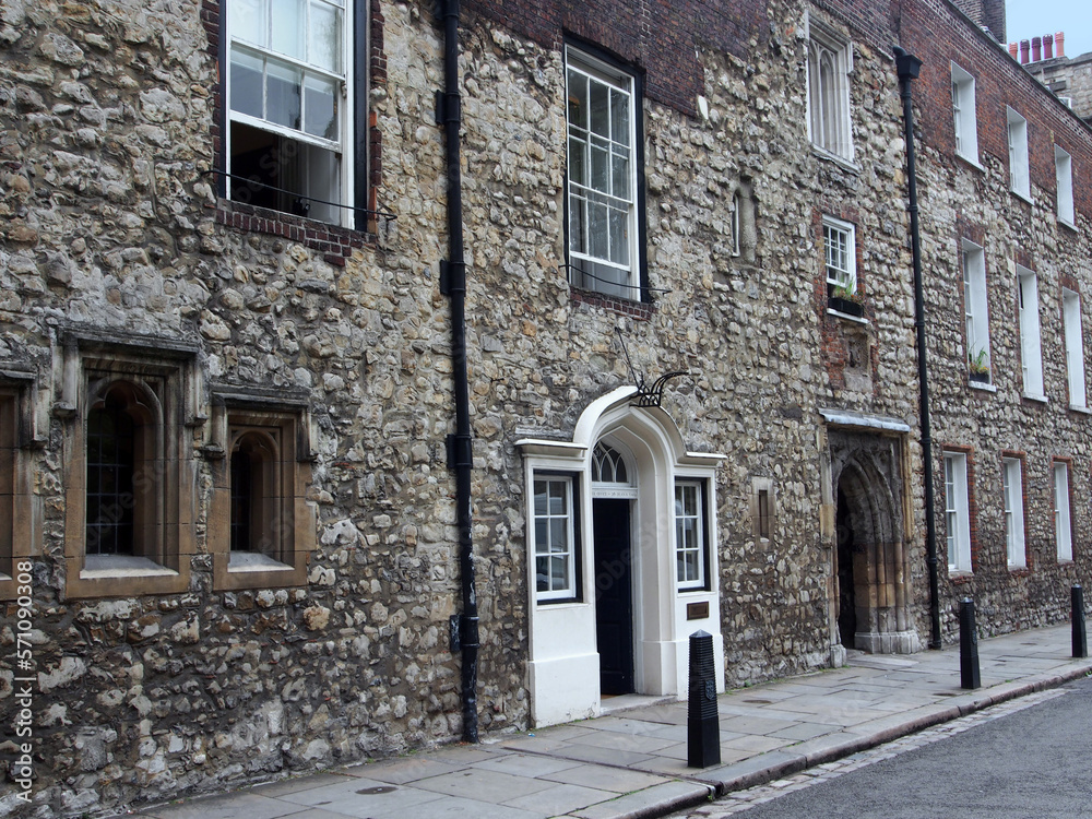 Obraz premium Ancient worn down stone facade around the entrance to Westminster School in London, dating from the middle ages, adjacent to Westminster Abbey