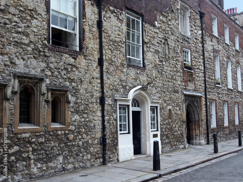 Ancient worn down stone facade around the entrance to Westminster School in London, dating from the middle ages, adjacent to Westminster Abbey