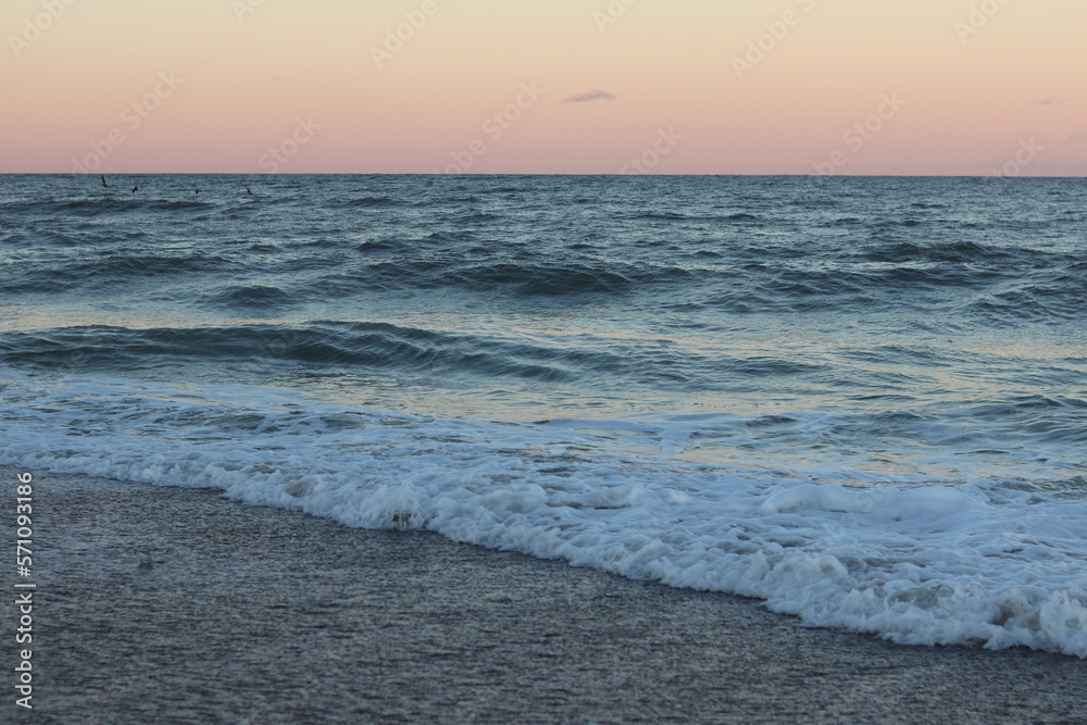 waves on the beach at sunset