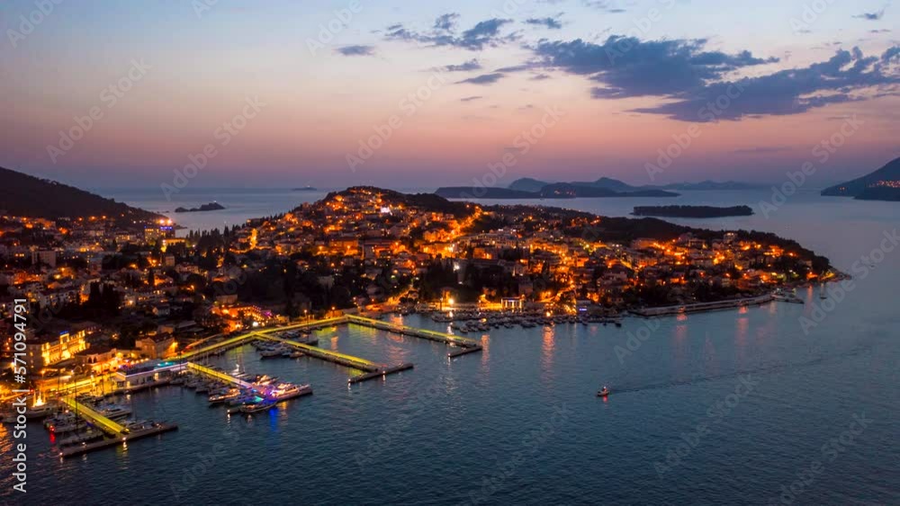 Aerial hyperlapse of Dubrovnik, Croatia lit up by city lights on a warm summer evening. Aerial hyperlapse of Dubrovnik, Croatia lit up by city lights on a warm summer evening.