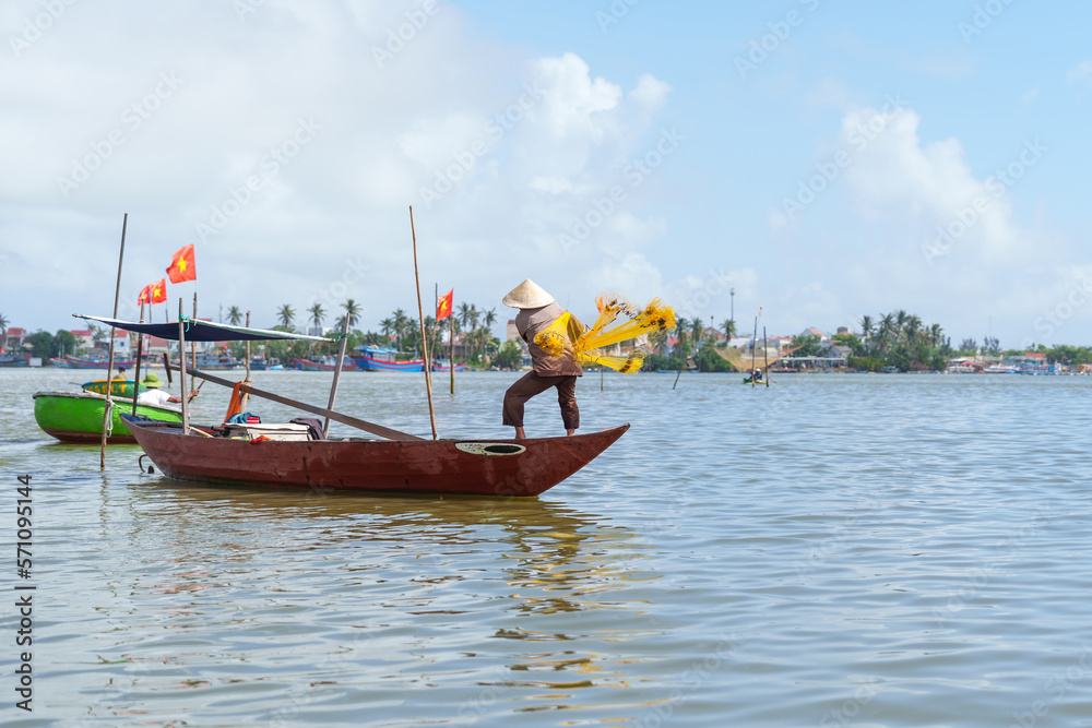 Fisherman Fishing Net on the boat at Cam thanh village. Landmark and popular for tourists attractions in Hoi An. Vietnam and Southeast Asia travel concepts Fisherman Fishing Net on the boat at Cam thanh village. Landmark and popular for tourists attractions in Hoi An. Vietnam and Southeast Asia travel concepts