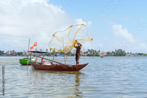 Fisherman Fishing Net on the boat at Cam thanh village. Landmark and popular for tourists attractions in Hoi An. Vietnam and Southeast Asia travel concepts