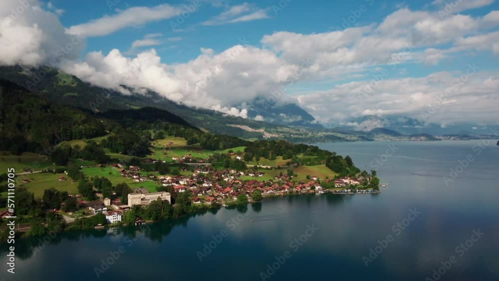 Slow circling drone shot showing the mountain town of Interlaken. Surrounding Thunersee in beautiful swiss alps Slow circling drone shot showing the mountain town of Interlaken. Surrounding Thunersee in beautiful swiss alps