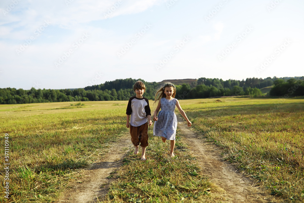 Children walk in the summer in nature. Child on a sunny spring morning in the park. Traveling with children.