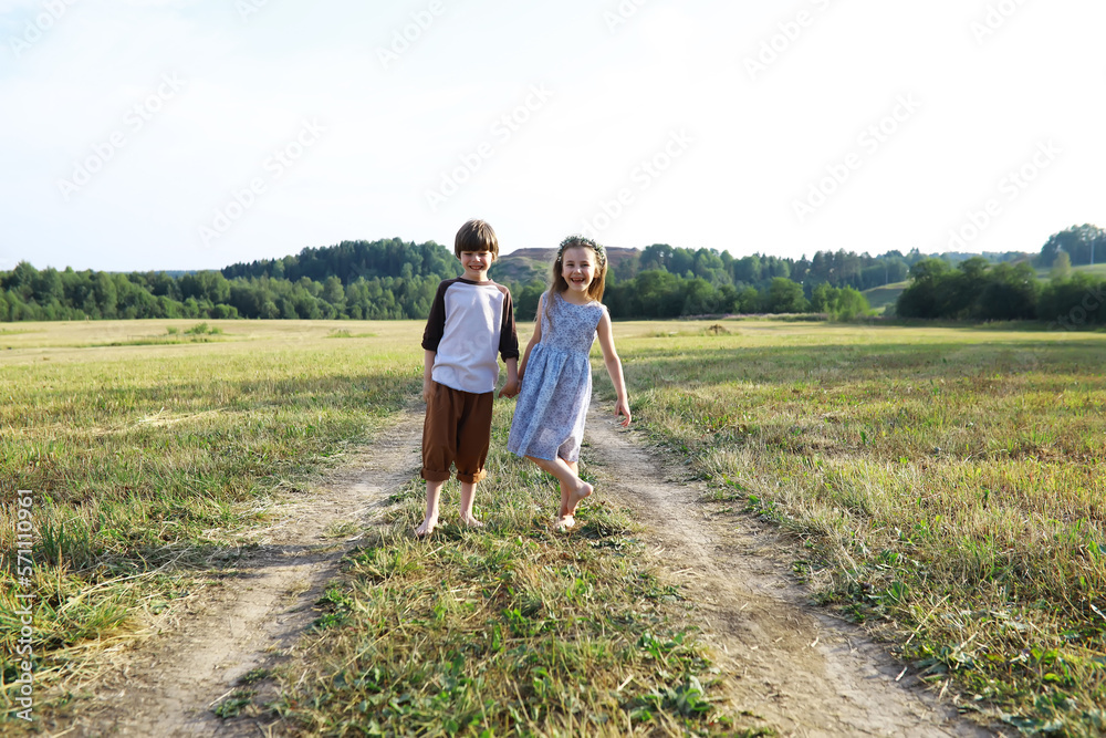 Children walk in the summer in nature. Child on a sunny spring morning in the park. Traveling with children.