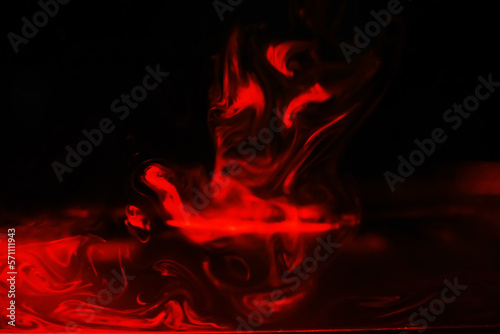 Red smoke over black studio background. Red steam on a black background. Copy space.