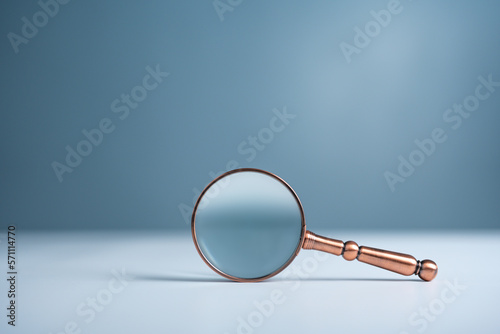 Close up magnifier glass on wooden table, the concept of searching or finding for an idea, Search for information, Find the answer.