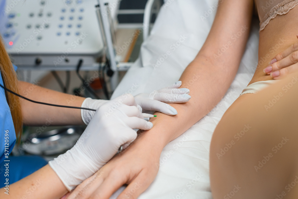 Fototapeta premium Electrolysis hair removal at hands in salon
