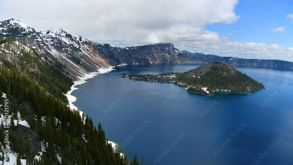Crater Lake - A time-lapse overview of blue Crater Lake and rocky Wizard Island on a cloudy Spring morning. Crater Lake National Park, Oregon, USA. Crater Lake - A time-lapse overview of blue Crater Lake and rocky Wizard Island on a cloudy Spring morning. Crater Lake National Park, Oregon, USA.