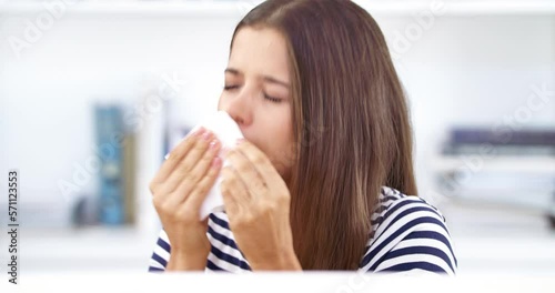 Sneeze, tissue and face of a woman in her office with the flu, covid or hayfever allergies. Sick, illness and portrait of a female employee with sinus, cold or allergy blowing her nose in workplace. photo