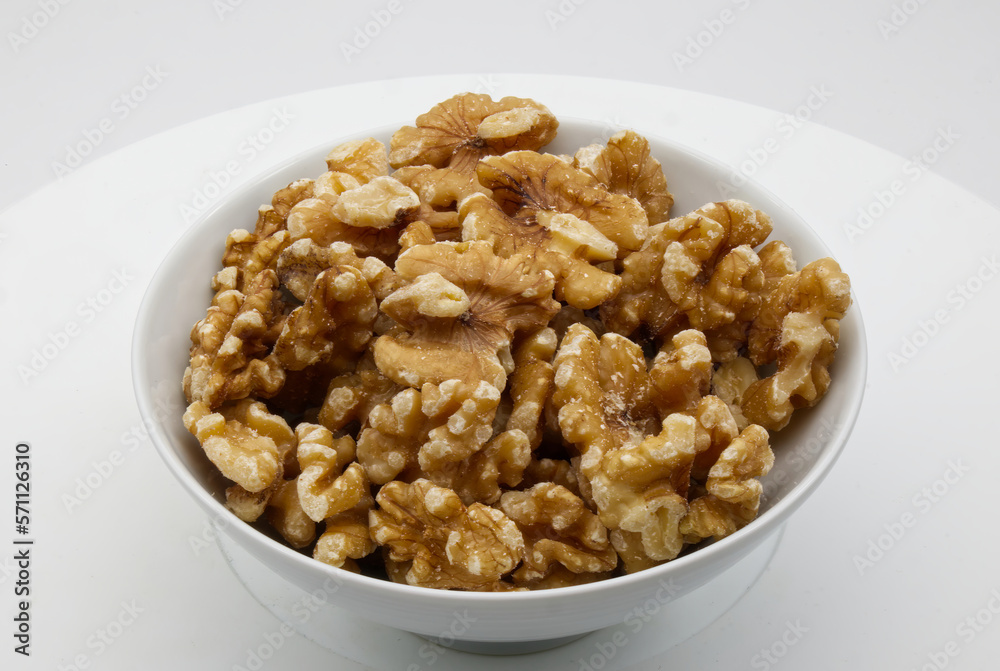 Walnut in a white bowl isolated on white background Walnut in a white bowl isolated on white background