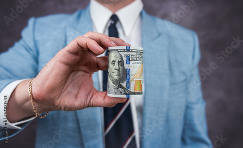 Man's hand showing 100 dollar bills. Businessman counts money