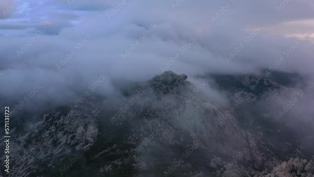 Aerial overview of Italian mountains, covered in thick fog, on a gloomy evening Aerial overview of Italian mountains, covered in thick fog, on a gloomy evening