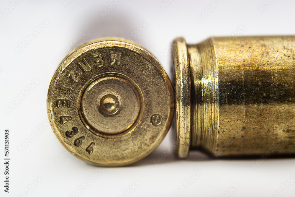 two machine gun cartridge cases on color gradient background close up two machine gun cartridge cases on color gradient background close up