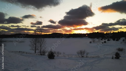 Sun setting on Lake Michigan near a frozen Inland lake. photo