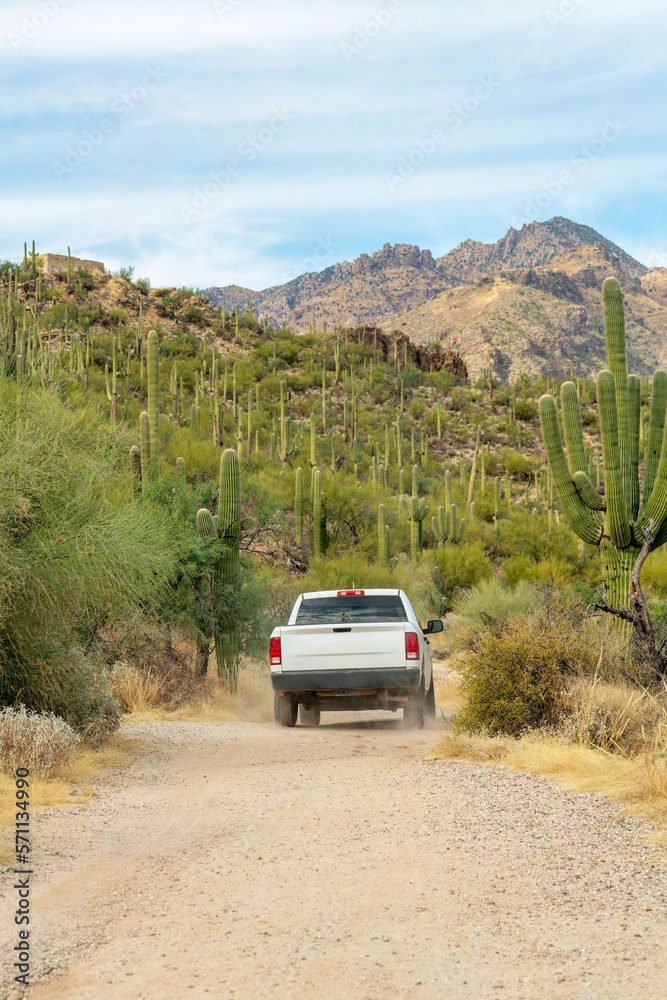 White truck in the hills of arizona on hiking or walking trail with mountain background and natural vegetation White truck in the hills of arizona on hiking or walking trail with mountain background and natural vegetation
