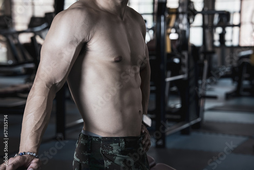 Close up view of sexy body of young man with six pack muscular and athletic body on black background. concept of health care, exercise, fitness, muscle mass, health supplements.