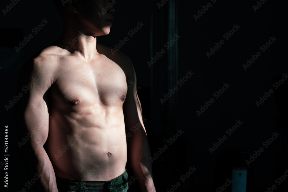 Sexy body of muscular young Asian man in gym. Concept of health care, exercise fitness, Strong muscle mass, body enhancement, fat reduction for men's health supplement product presentation. Sexy body of muscular young Asian man in gym. Concept of health care, exercise fitness, Strong muscle mass, body enhancement, fat reduction for men's health supplement product presentation.