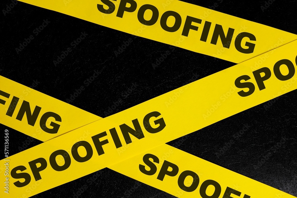 Spoofing cybercrime alert, caution and warning concept. Yellow barricade tape with word spoofing in dark black background.