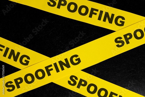 Obraz na płótnie Spoofing cybercrime alert, caution and warning concept. Yellow barricade tape with word spoofing in dark black background. w salonie