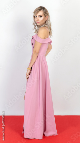 Model studio session. Pretty, shapely blonde. Long pink dress