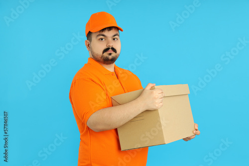 Concept of people, delivery man on blue background