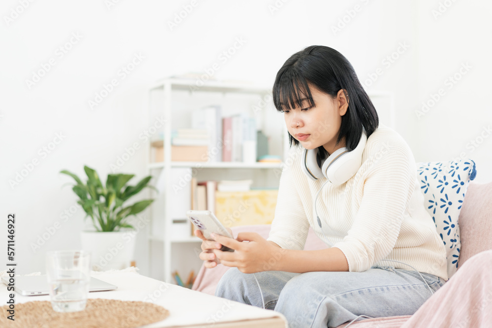 Stressed. Asian teenager text on smartphone. Asia woman using mobile phone Stressed. Asian teenager text on smartphone. Asia woman using mobile phone