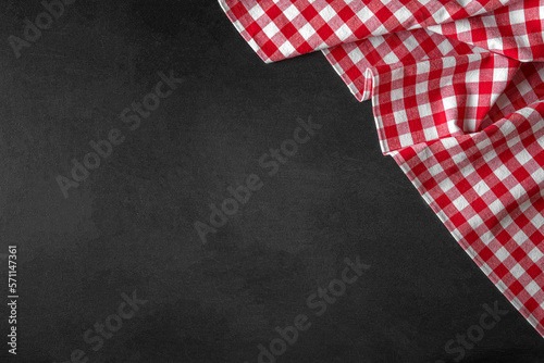 Checkered tablecloth on a black background. There is space for text.