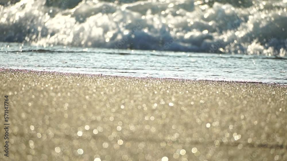 Small sea wave, Blurred Soft foamy waves washing golden sandy beach on sunset. Ocean Waves On Sandy Beach. Nobody. Holiday recreation concept. Abstract nautical summer ocean sunset nature background. Small sea wave, Blurred Soft foamy waves washing golden sandy beach on sunset. Ocean Waves On Sandy Beach. Nobody. Holiday recreation concept. Abstract nautical summer ocean sunset nature background.