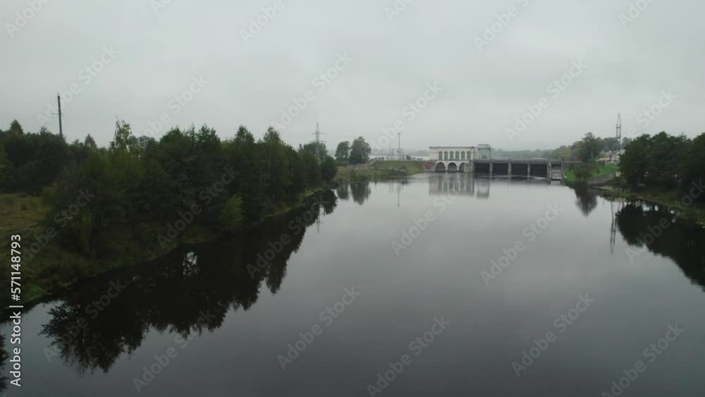 Small power plant on the river, view from height of the dam system, energy extraction. Small power plant on the river, view from height of the dam system, energy extraction.