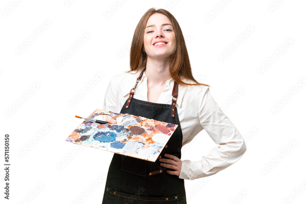 Young artist woman holding a palette over isolated chroma key background posing with arms at hip and smiling Young artist woman holding a palette over isolated chroma key background posing with arms at hip and smiling