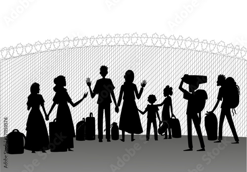 silhouette of refugees behind the fence