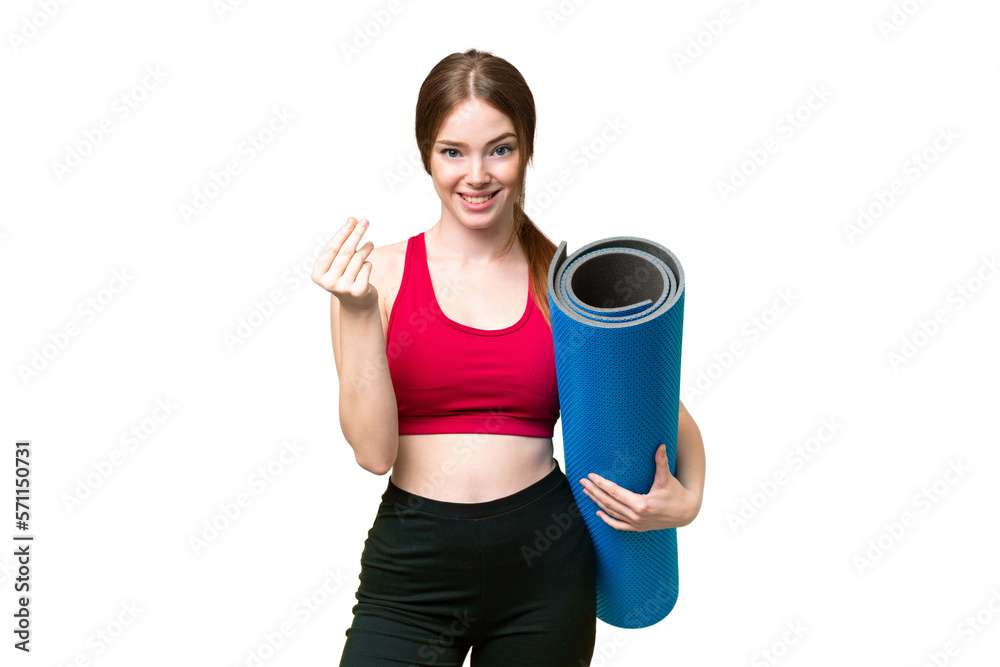 Young sport woman going to yoga classes while holding a mat over isolated chroma key background making money gesture Young sport woman going to yoga classes while holding a mat over isolated chroma key background making money gesture