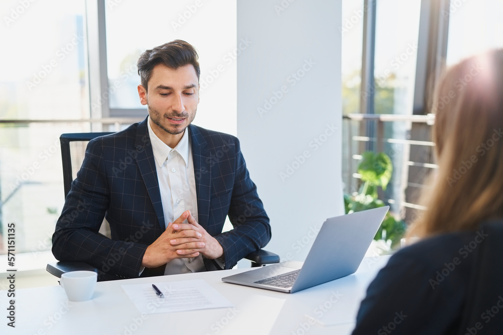 Recruiter talking to candidate in interview at office Recruiter talking to candidate in interview at office