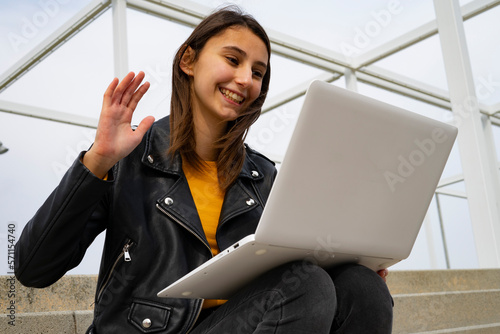 Young woman talking on webcam at the computer.
