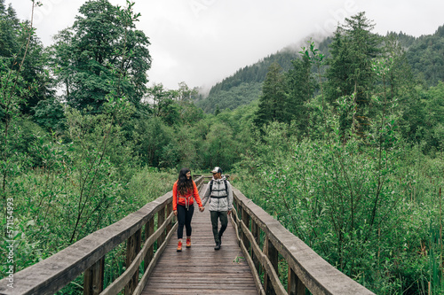 A young couple hikes on a trail in Mt. Hood National Forest in Oregon.