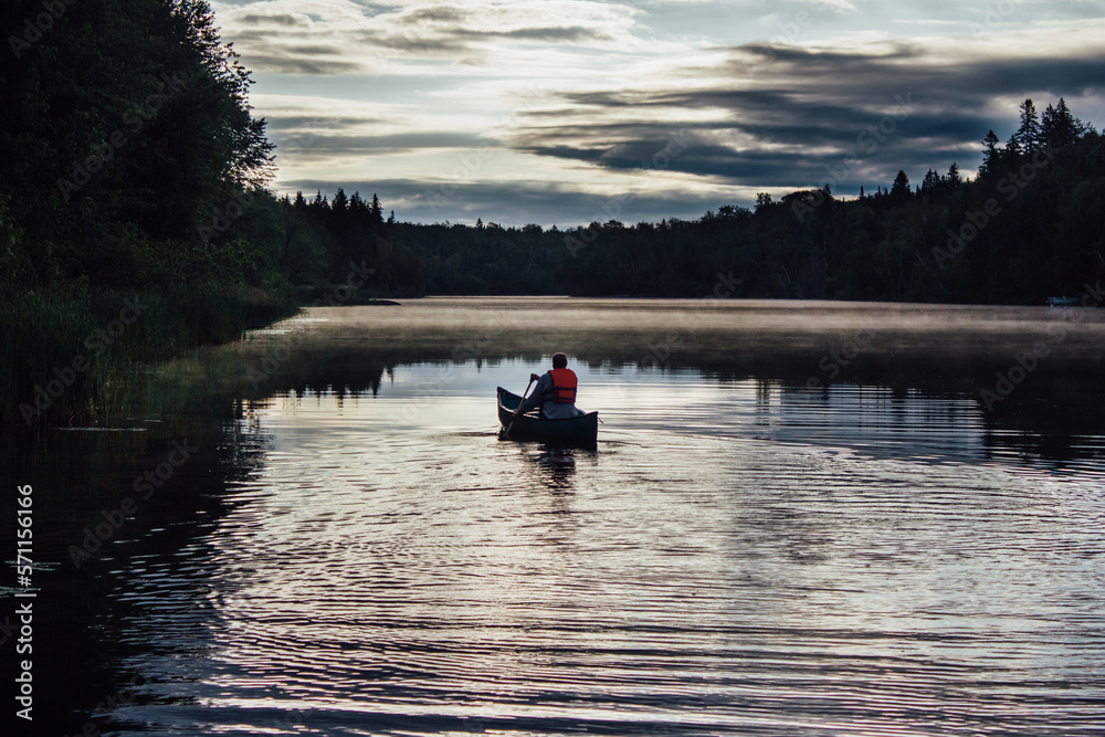 Man canoeing at dawn on misty Spanish River in Massey Ontario Canada Man canoeing at dawn on misty Spanish River in Massey Ontario Canada