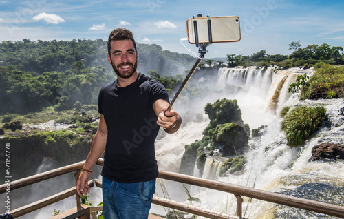 man taking a selfie with monopod at Iguazu waterfalls in Argentina photo