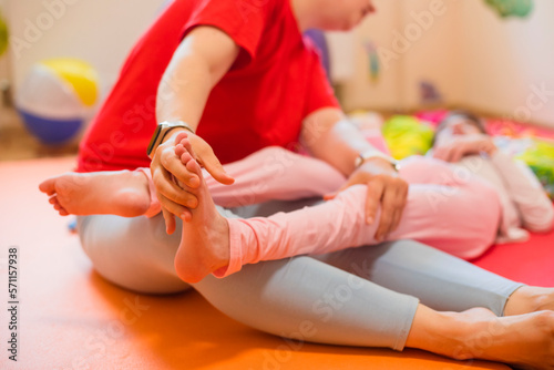 Physical therapist examining cerebral palsy patient's foot photo