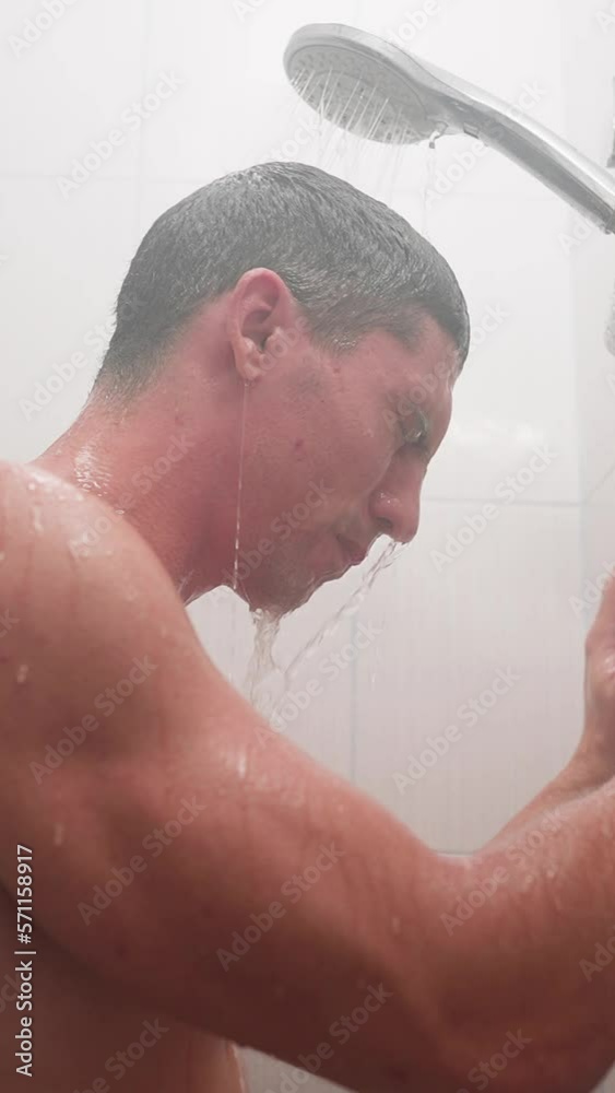 Vertical Video, Naked Sad Man Stands in the Shower Under a Stream of Water. Concept of Anxiety and Depression. Mental Problems. Slow Motion. Vertical Video, Naked Sad Man Stands in the Shower Under a Stream of Water. Concept of Anxiety and Depression. Mental Problems. Slow Motion.