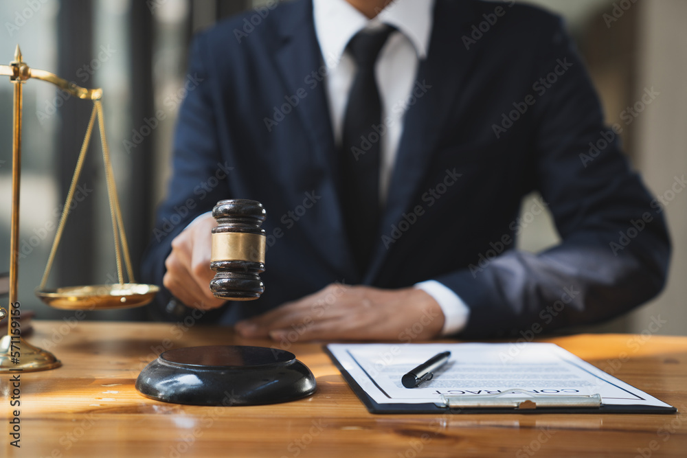 Justice lawyer office with scales and young lawyer, smart Asian legal consultant, and skill in using a hammer in law office Advice and ideas about justice.