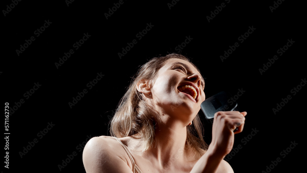 Positive girl singing song with hair brush on camera, playing around being funny and showing confidence. Young adult with glowing skin having fun with beauty and skincare ad campaign. Positive girl singing song with hair brush on camera, playing around being funny and showing confidence. Young adult with glowing skin having fun with beauty and skincare ad campaign.