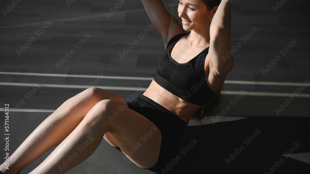 beautiful athletic woman working ab intervals in fitness