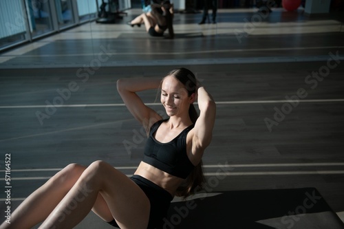 beautiful athletic woman working ab intervals in fitness © Serhii