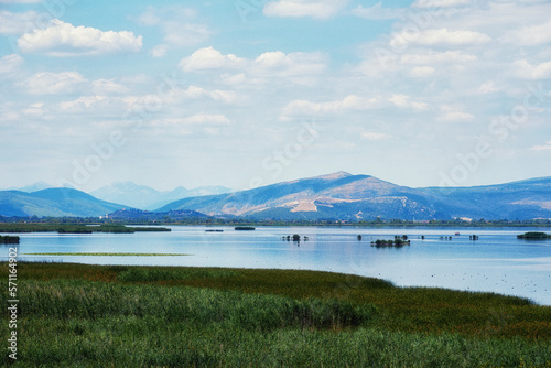 Big tranquil blue lake with a mountains range on the back. Landscape backgrounds