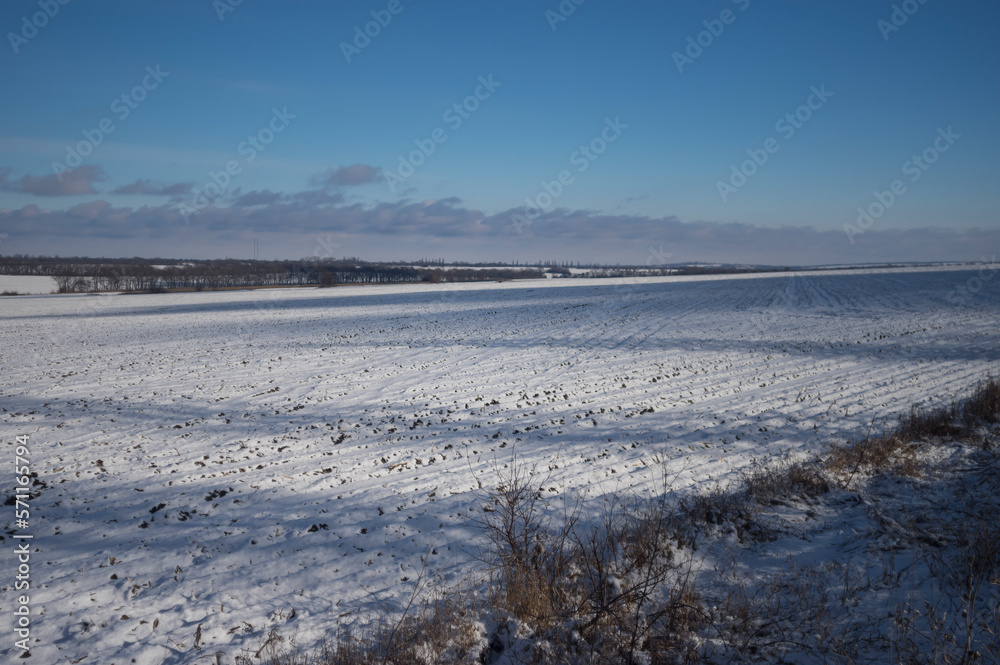 Ukrainian landscape with agrilultural filds cobered with snow near  Verkhnyodniprovsk city located in Dnipropetrovsk Oblast (province)