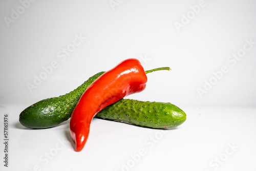Fresh Cucumber and red pepper isolated on white background tasty and healthy food flat side view