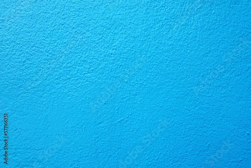 Blue cement wall background with rough, textured surface. Ideal for use as pastel wallpaper, abstract design, decorative banner, or grunge template, providing ample copy space, colorful effect.