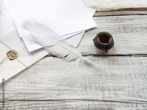 Envelope and paper on white wooden table